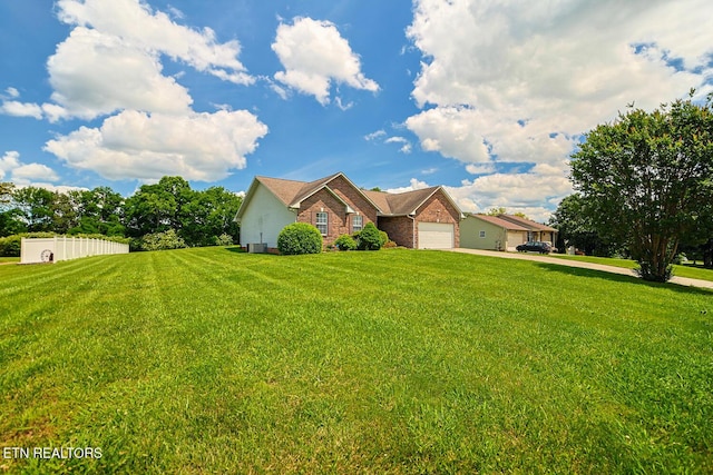 ranch-style house with concrete driveway, brick siding, and a front yard