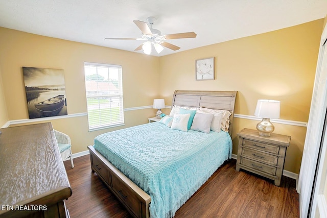 bedroom featuring wood finished floors, baseboards, and ceiling fan