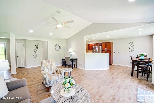 living room featuring lofted ceiling, light wood-style floors, a ceiling fan, baseboards, and recessed lighting