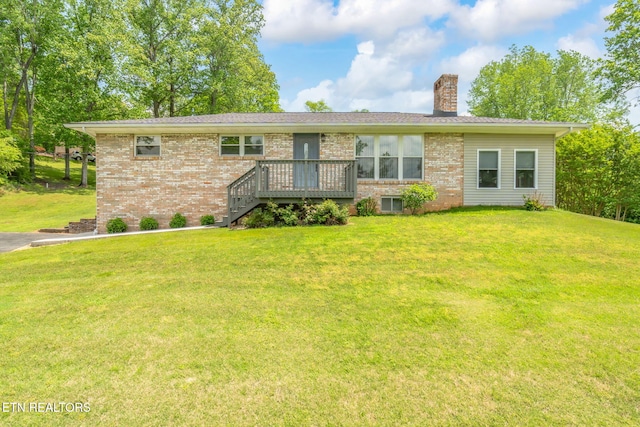 ranch-style home with brick siding, a front lawn, a wooden deck, and a chimney