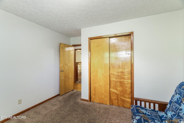 bedroom with carpet floors, baseboards, and a closet