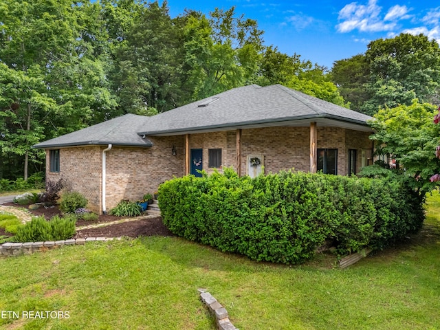 1819 Big Buck Ln, Sevierville, TN 37876 - view of front of home featuring a front yard, brick siding, and a shingled roof