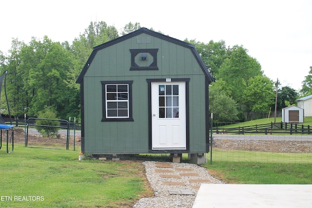 view of shed with fence