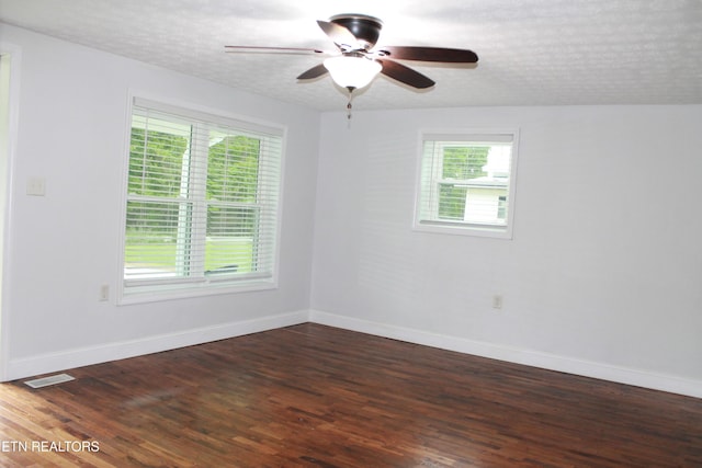 empty room with baseboards, visible vents, and ceiling fan