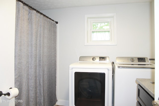 washroom with washer and dryer