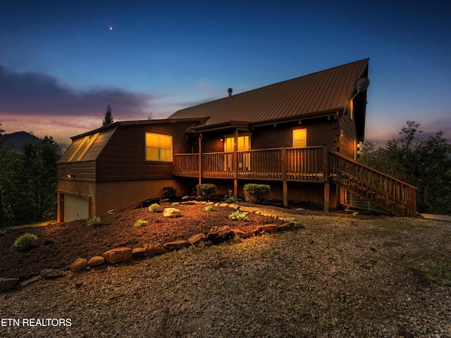 155 George Thomas Rd, Vonore, TN 37885 - back of house at dusk with stairs, metal roof, and a deck