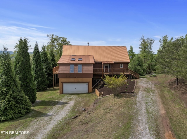 155 George Thomas Rd, Vonore, TN 37885 - view of front of home featuring an attached garage, stairway, metal roof, a wooden deck, and dirt driveway