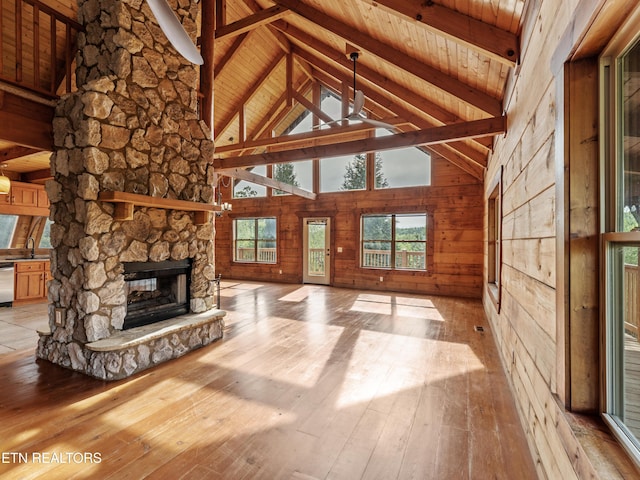 155 George Thomas Rd, Vonore, TN 37885 - unfurnished living room featuring wooden ceiling, light wood finished floors, a stone fireplace, and beam ceiling