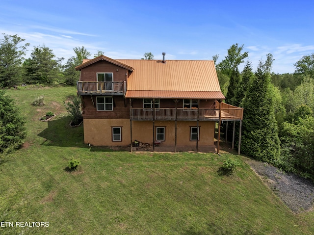 155 George Thomas Rd, Vonore, TN 37885 - rear view of property featuring a lawn, metal roof, stucco siding, and a deck