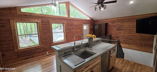 2165 Street Place Loop, Monterey, TN 38574 - kitchen with a sink, vaulted ceiling, wooden walls, stainless steel dishwasher, and wood finished floors