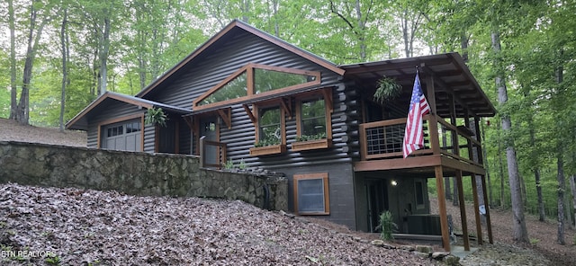 2165 Street Place Loop, Monterey, TN 38574 - back of property with log exterior, an attached garage, and a wooden deck