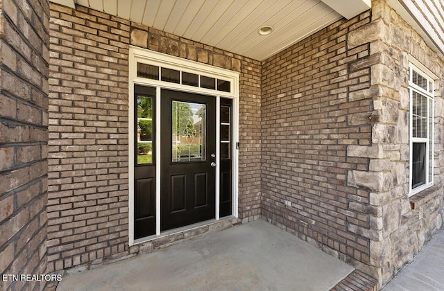 entrance to property with brick siding