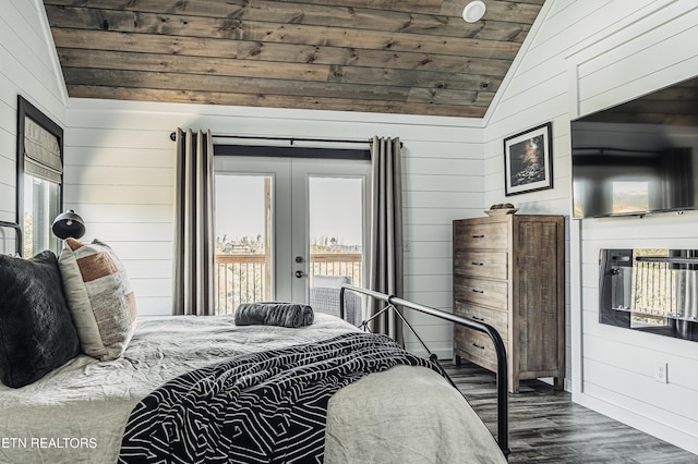 bedroom with lofted ceiling, french doors, wooden walls, wood finished floors, and access to exterior
