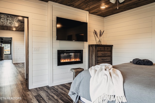 bedroom with dark wood-style flooring, wood walls, and wooden ceiling