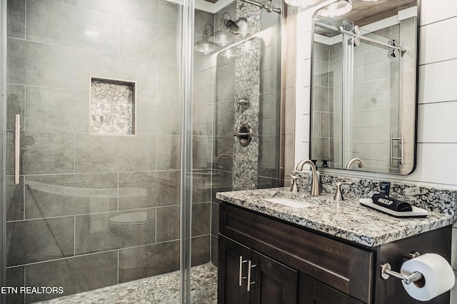 full bath featuring vanity and a shower stall