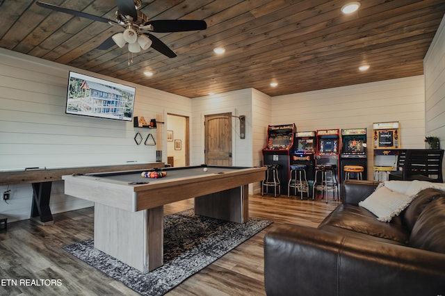 game room with wood ceiling, wood finished floors, a ceiling fan, wooden walls, and billiards