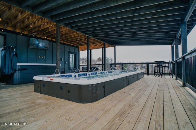 wooden terrace with a hot tub