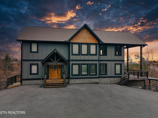 chalet / cabin featuring board and batten siding and roof with shingles