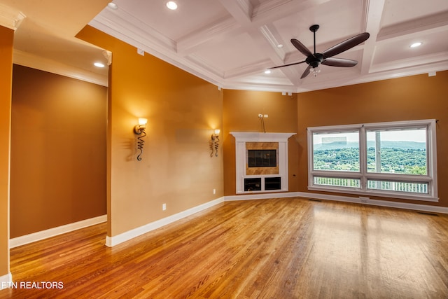 1012 Falcon Crest Dr, Seymour, TN 37865 - unfurnished living room featuring beam ceiling, wood finished floors, ornamental molding, a ceiling fan, and coffered ceiling