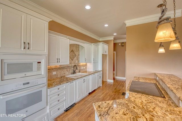 1012 Falcon Crest Dr, Seymour, TN 37865 - kitchen featuring ornamental molding, white appliances, a sink, light wood-style floors, and tasteful backsplash