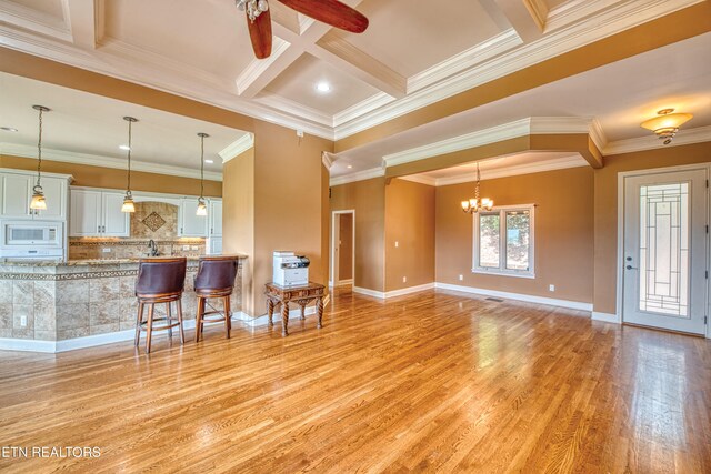 1012 Falcon Crest Dr, Seymour, TN 37865 - living area featuring beamed ceiling, light wood-style flooring, coffered ceiling, and ceiling fan with notable chandelier