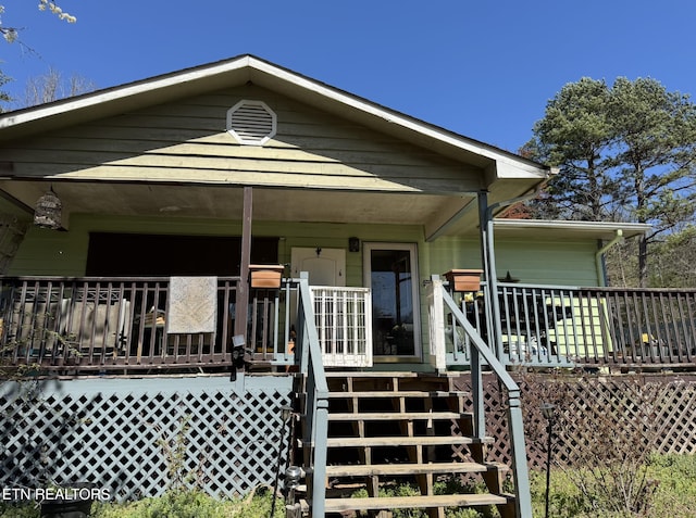 view of front of home featuring covered porch and stairway