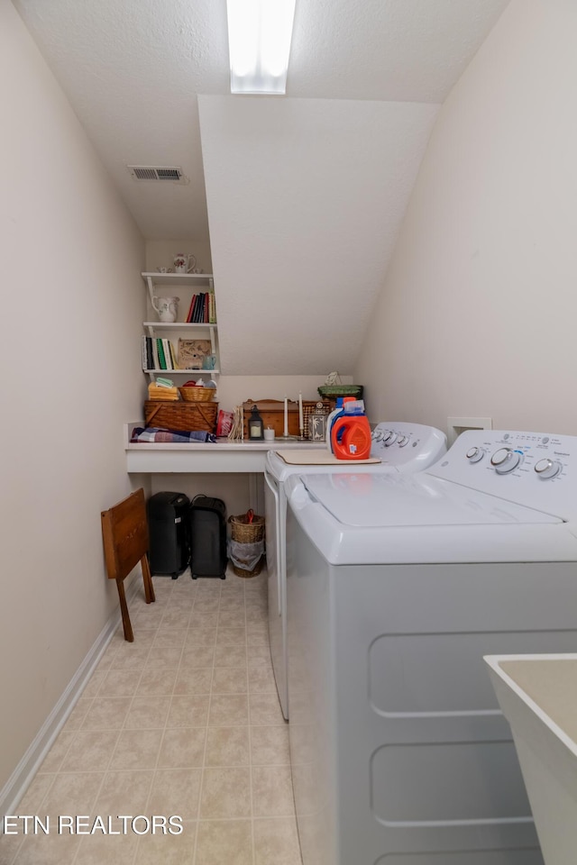 washroom featuring washing machine and dryer, laundry area, and visible vents