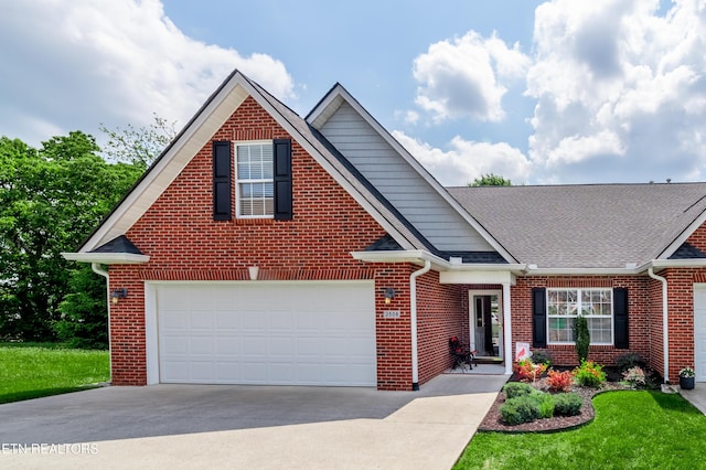 traditional-style house featuring concrete driveway, brick siding, and a shingled roof
