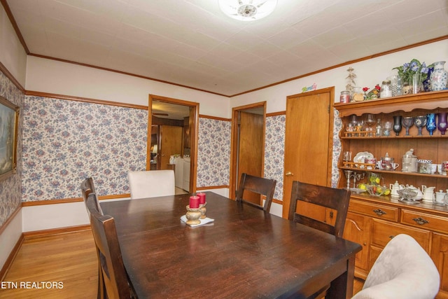 941 Pine Top St, Lenoir City, TN 37772 - dining space with crown molding, baseboards, wallpapered walls, and light wood-style flooring