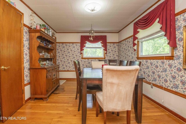 941 Pine Top St, Lenoir City, TN 37772 - dining room with crown molding, a healthy amount of sunlight, and light wood-style floors