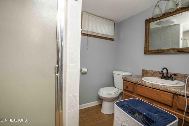 941 Pine Top St, Lenoir City, TN 37772 - bathroom featuring toilet, a shower with door, wood finished floors, and vanity