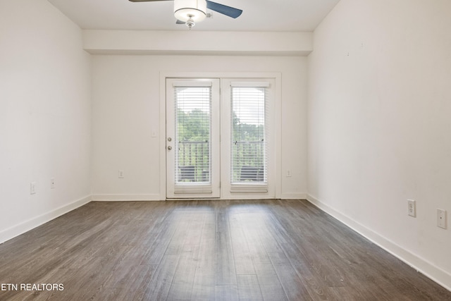 empty room with dark wood-type flooring, baseboards, and ceiling fan