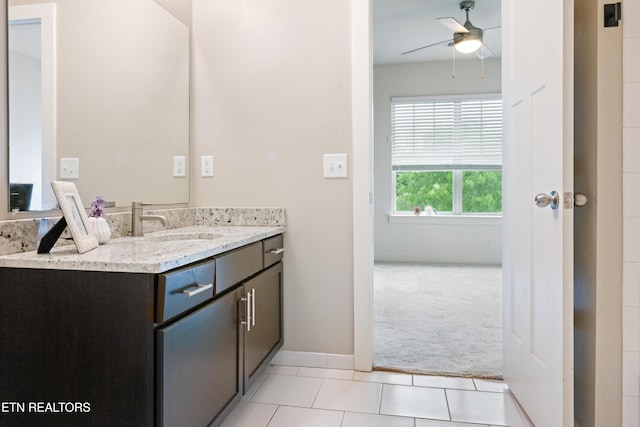 bathroom featuring ceiling fan, baseboards, tile patterned flooring, and vanity