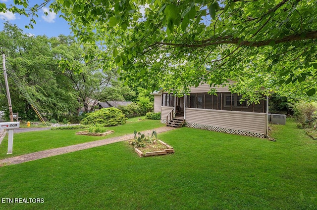 view of yard with a sunroom