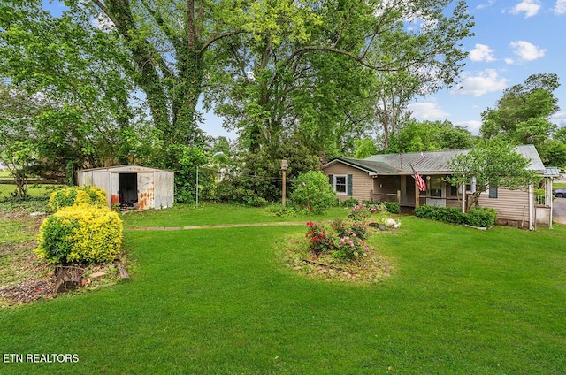 view of yard featuring a storage shed, an outdoor structure, and covered porch