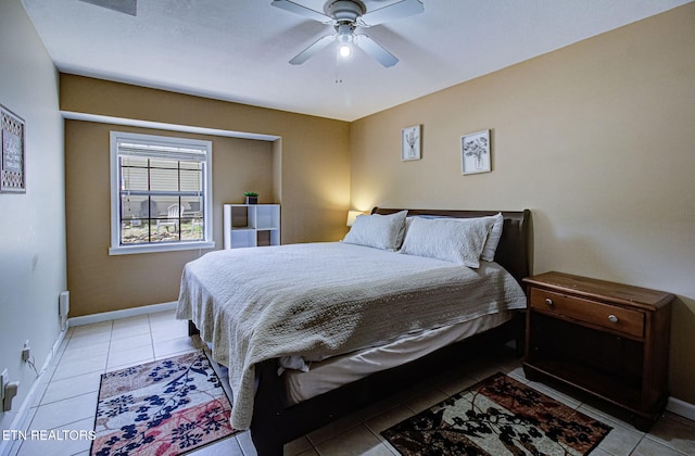 bedroom featuring baseboards, a ceiling fan, and light tile patterned floors
