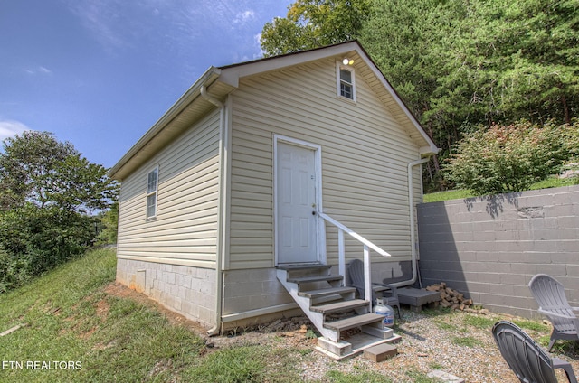 view of outdoor structure with fence and entry steps