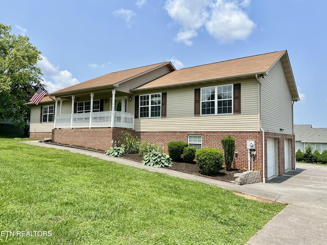 1533 Kildee Ln, Sevierville, TN 37862 - view of front of property featuring asphalt driveway, a garage, a front lawn, covered porch, and brick siding