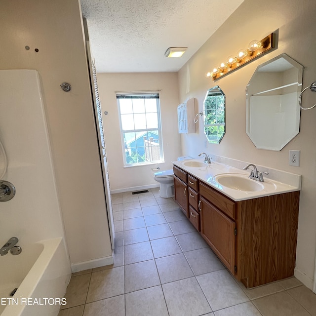 1533 Kildee Ln, Sevierville, TN 37862 - bathroom featuring tile patterned floors, double vanity, a textured ceiling, tub / shower combination, and baseboards