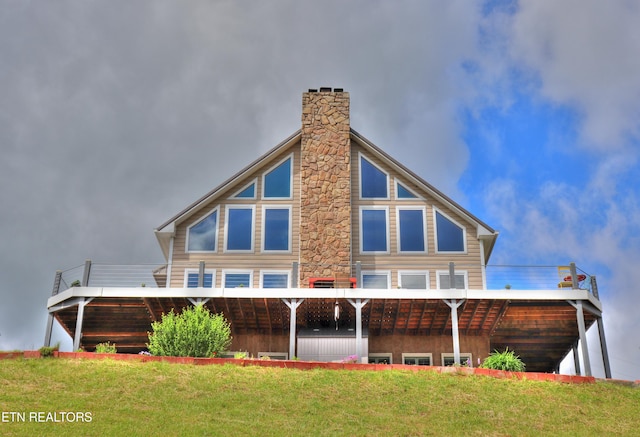 rear view of property with a lawn and a chimney