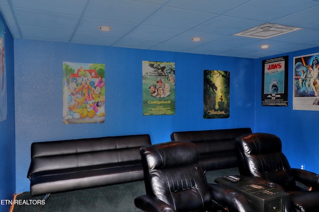 carpeted cinema with a paneled ceiling and recessed lighting