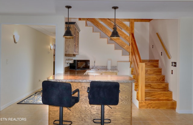 bar featuring black microwave, stairs, and light tile patterned flooring