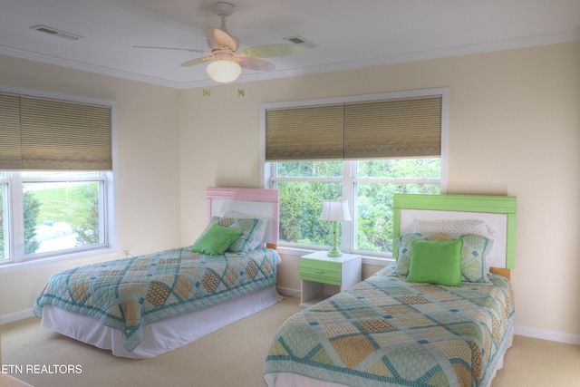 carpeted bedroom featuring crown molding, baseboards, and a ceiling fan
