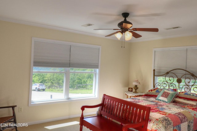 bedroom featuring baseboards, crown molding, and ceiling fan
