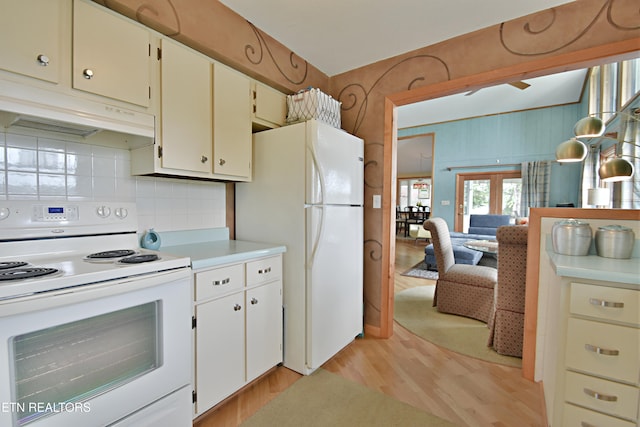 kitchen with light wood-style flooring, white appliances, under cabinet range hood, light countertops, and tasteful backsplash