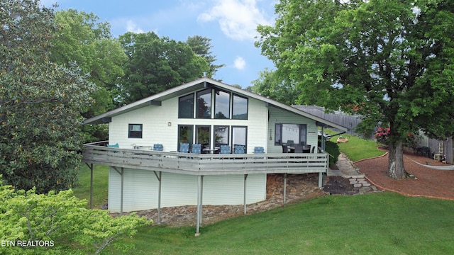 rear view of property with a yard and a deck