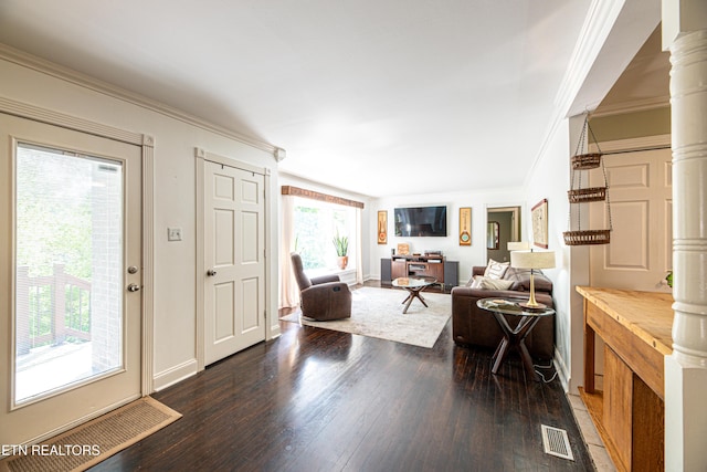 entrance foyer featuring visible vents, wood finished floors, ornate columns, and ornamental molding