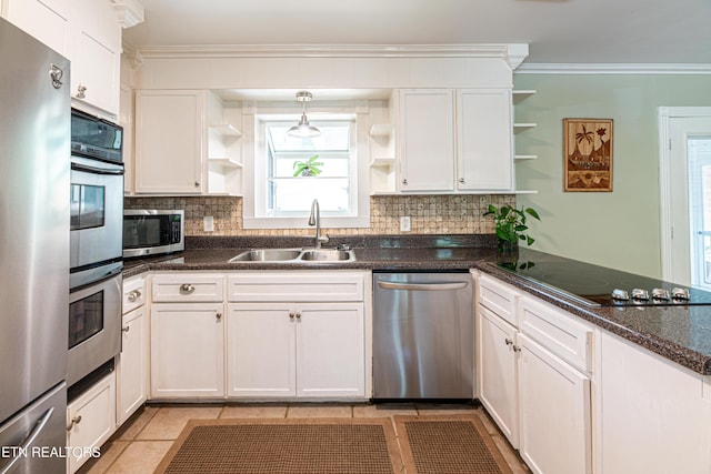 kitchen with stainless steel appliances, open shelves, decorative backsplash, and a sink
