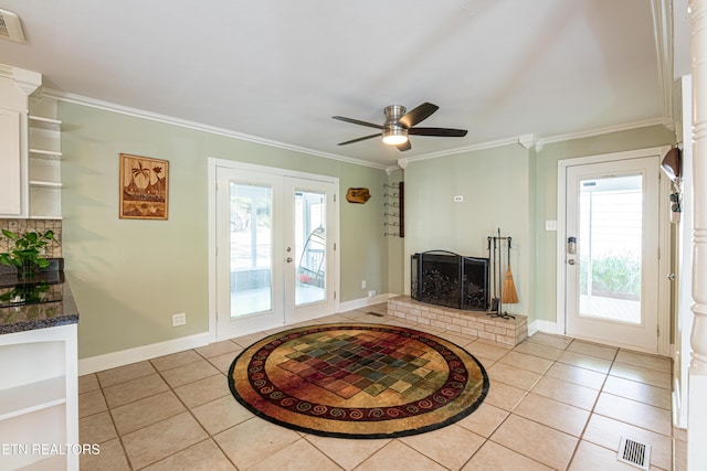 living area featuring ornamental molding, baseboards, french doors, and light tile patterned floors