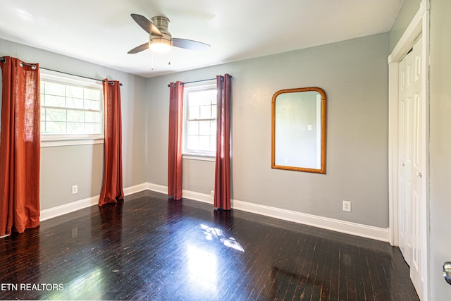 unfurnished room with baseboards, ceiling fan, and wood finished floors